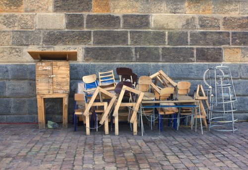 Cluttered living space being cleared by professionals