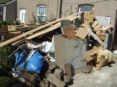 Hoarder clearance professionals organizing items in a cluttered room